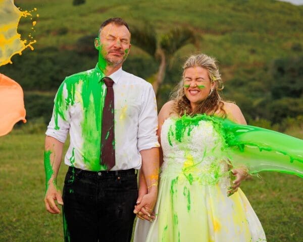 Bride and groom being splashed by lumo liquids