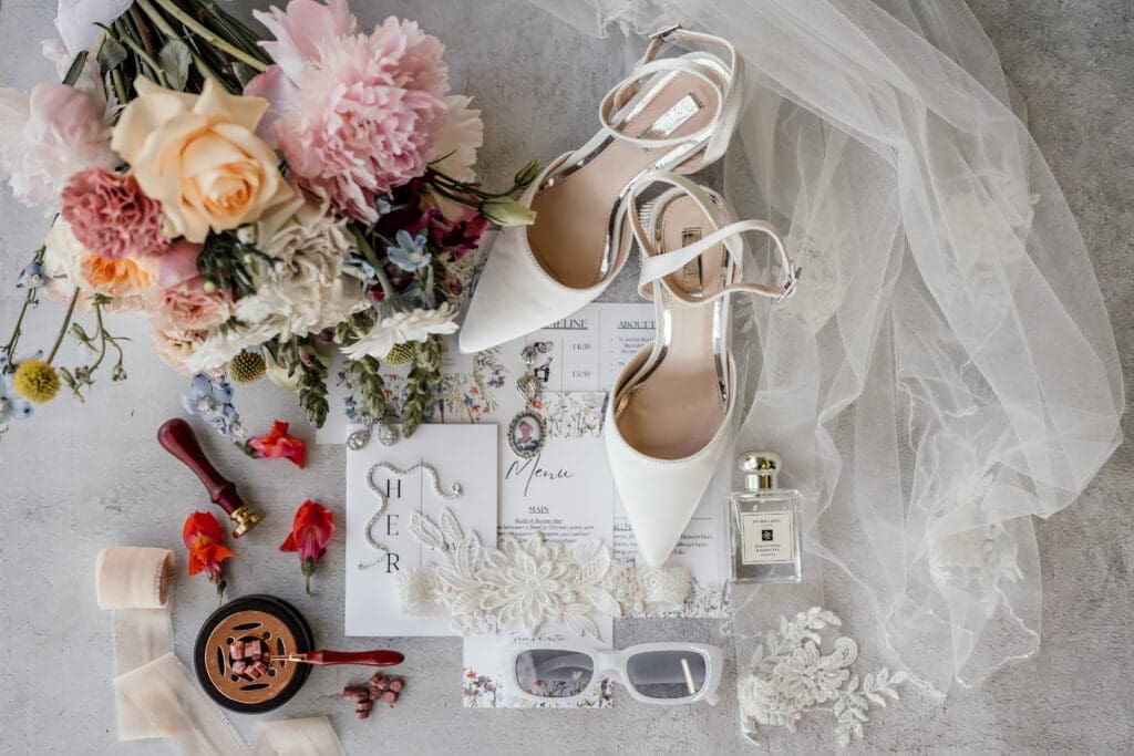 Wedding stationery and details image with bouquet and veil