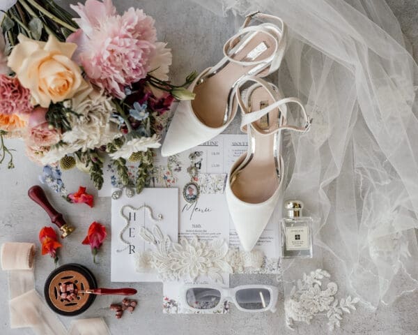 Wedding stationery and details image with bouquet and veil
