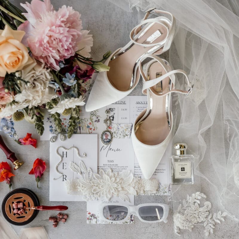 Wedding stationery and details image with bouquet and veil