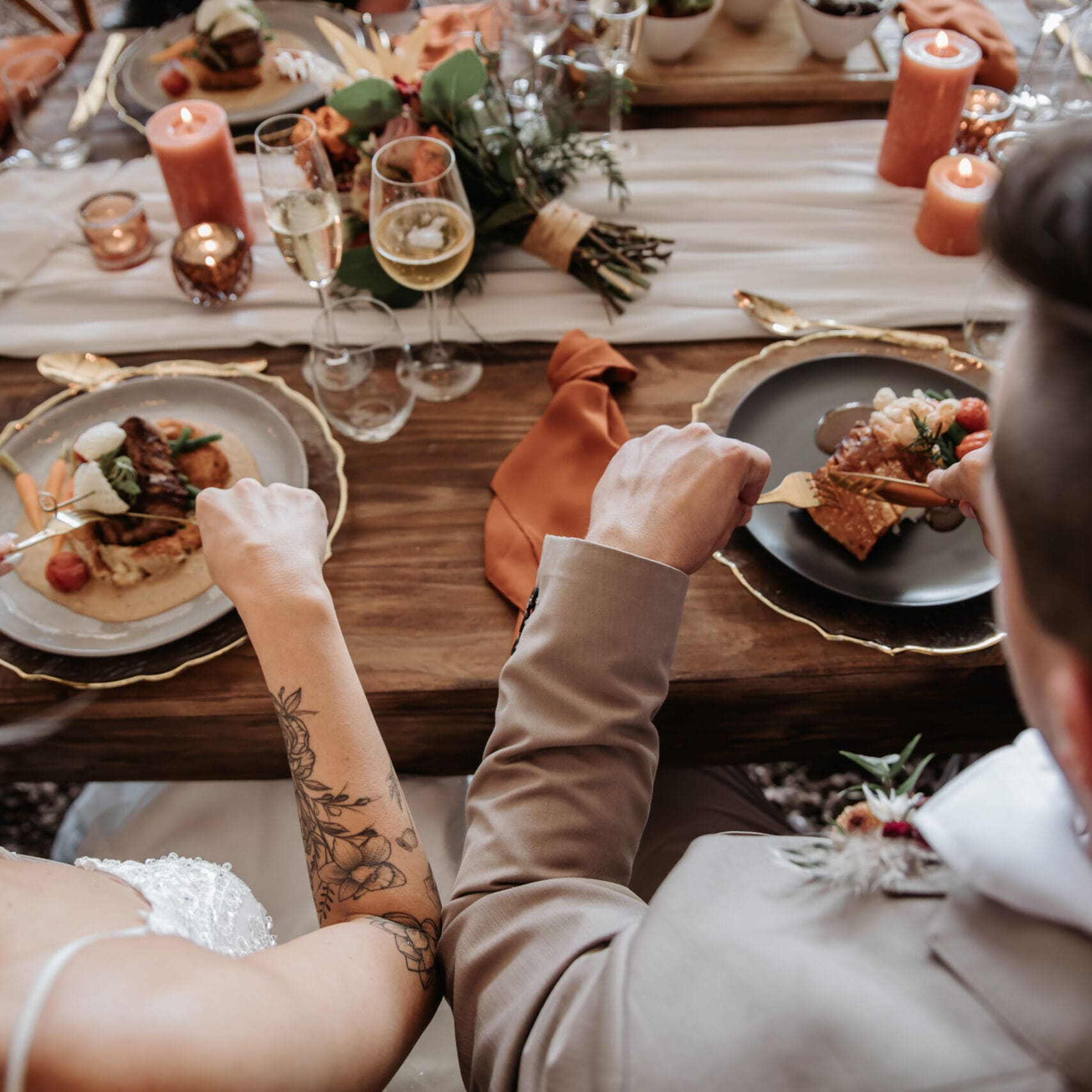 Newlyweds eating dinner at wedding reception